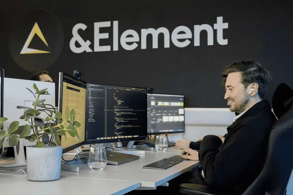 Luke Brown working at his desk in the &Element studio