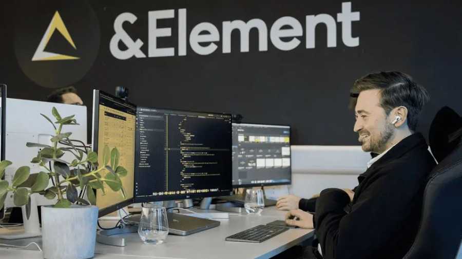 Luke Brown working at his desk in the &Element studio